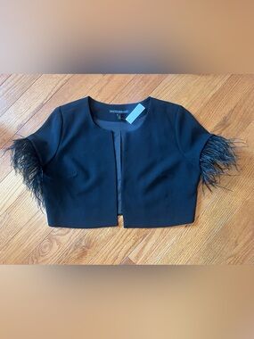 White House Black Market cropped blazer features feathers on the cuffs.